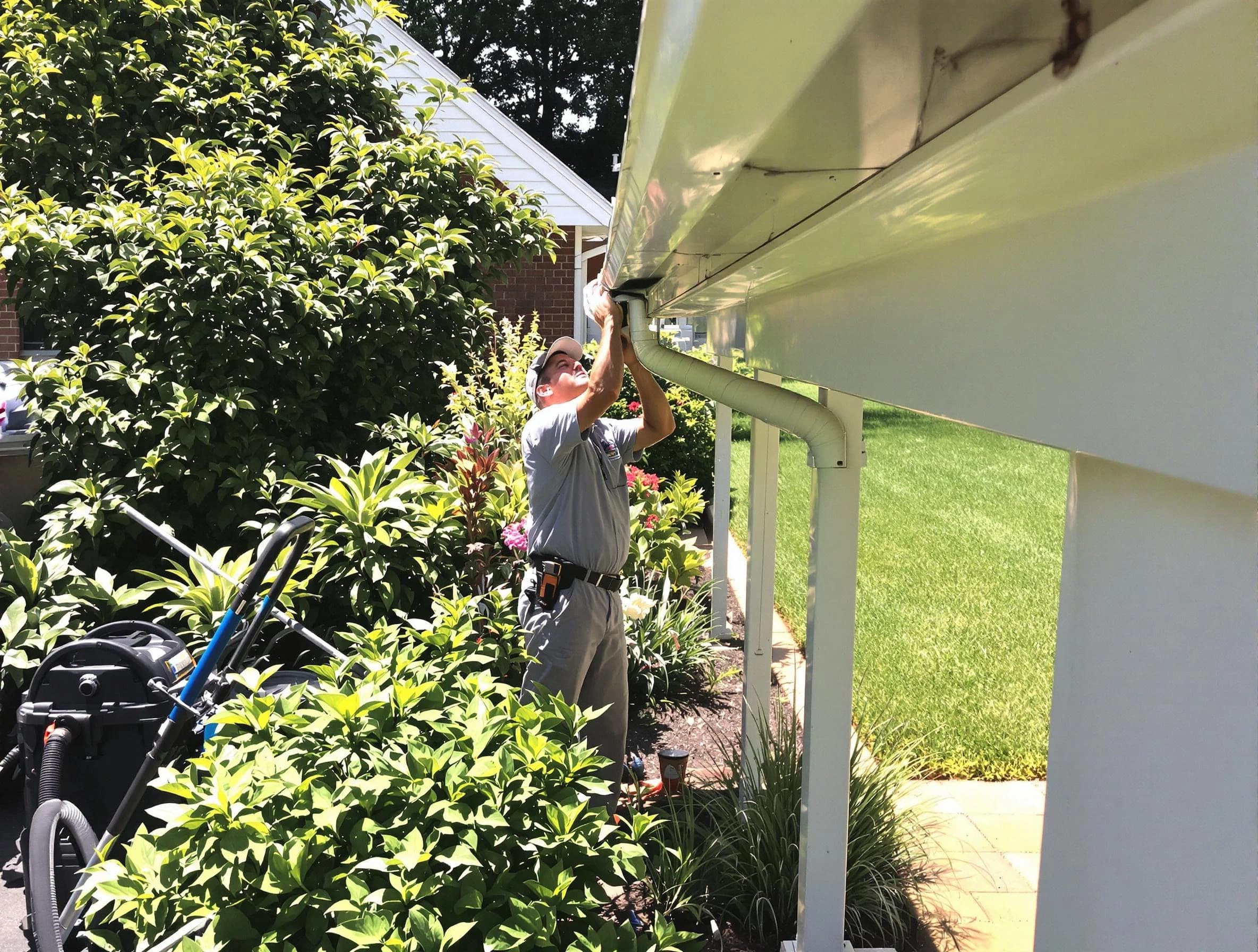 Technician flushing a blockage from a downspout in Strongsville, OH